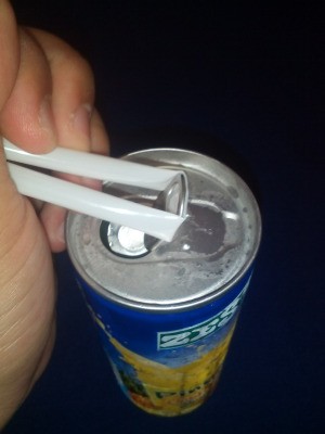 A straw placed under a ring tab to open it.