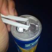 A straw placed under a ring tab to open it.