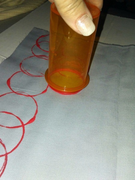 Fabric Stamping Art Project - beginning to stamp red circles on cloth