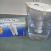 A Brita water filter pitcher with freezer tape holding the lid in place.