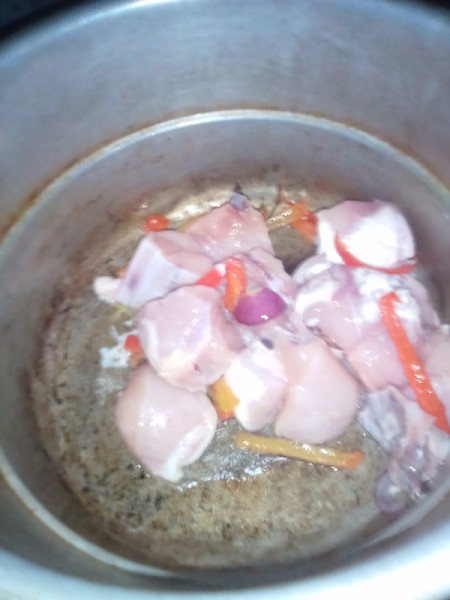 Chicken added to red pepper and onion in pan