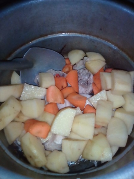 added potatoes and carrots to chicken in pan