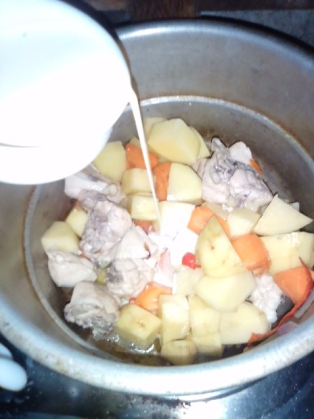milk added to chicken and vegetables in pan