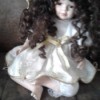 Value of Porcelain Doll - doll with long curly hair wearing a flower wreath