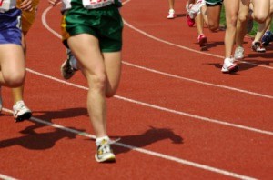 People running at a high school track meet.