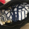 Handbag stuffed with clothes.