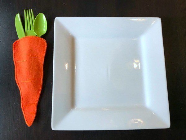 Felt Carrot Utensil Holder - carrot utensil holder next to square white plate