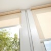 Cream colored roller blinds.