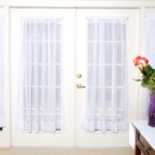 French doors with sheer window curtains.