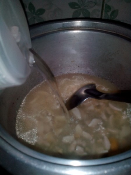 Adding water to porridge.