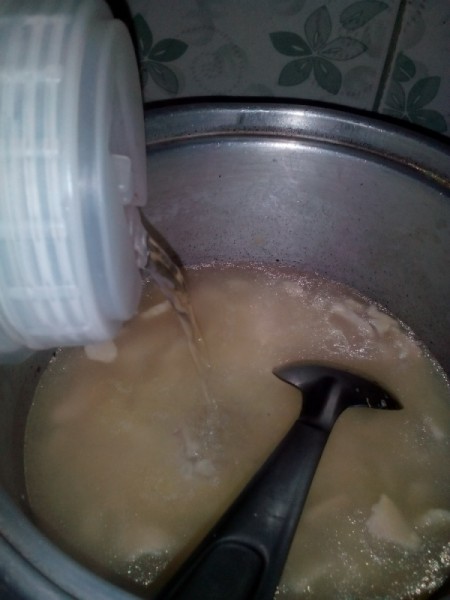 Adding water to porridge.