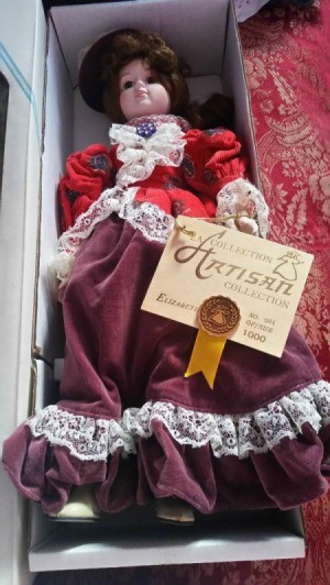 Information on Porcelain Doll - doll in box, wearing a red and purple period outfit