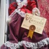 Information on Porcelain Doll - doll in box, wearing a red and purple period outfit