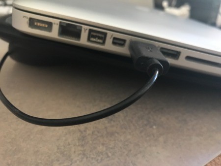 A cooling pad plugged into a laptop.