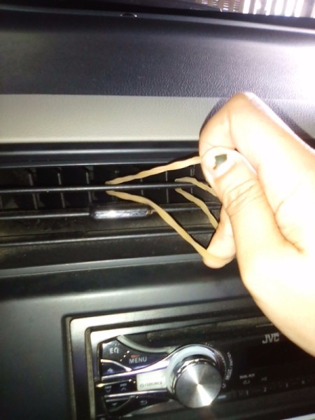 A rubber band in a vent, for holding a cellphone.