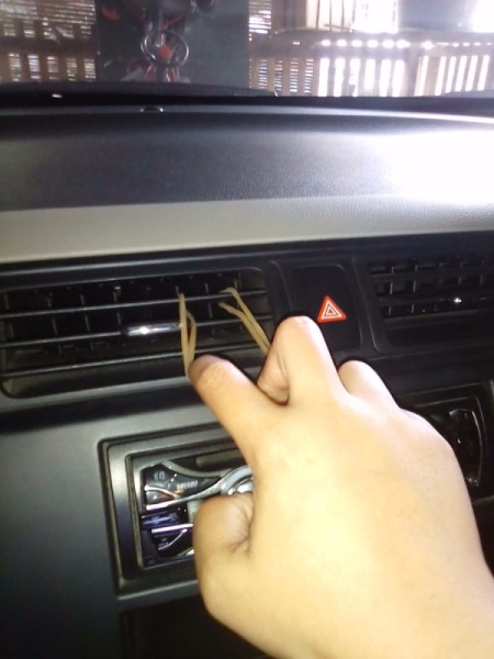 A rubber band in a vent, for holding a cellphone.