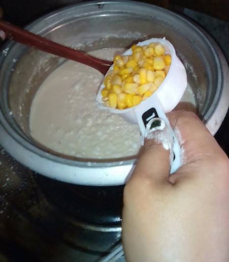 adding corn to pudding