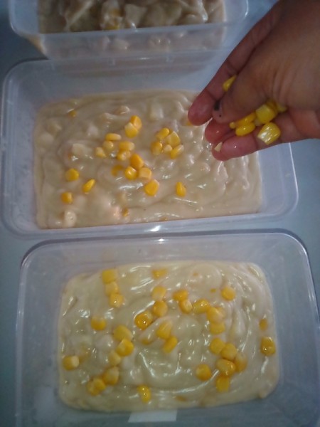 adding corn to small containers