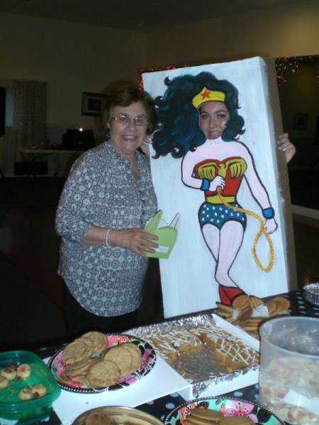 Photo Cutouts for Any Party - guest next to someone with their face showing through the Wonder Woman poster