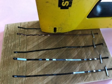 Bobby Pin Thumb Piano - begin stapling each pin down beginning close to the end of the first bobby pin and moving further away on each successive one