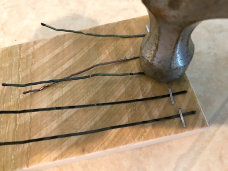 Bobby Pin Thumb Piano - tap staples down with a hammer