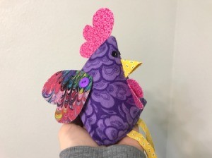 Fabric Chicken Doorstop - being held in palm of hand