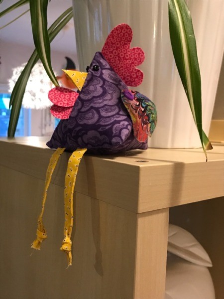 Fabric Chicken Doorstop - sitting on top of room divider