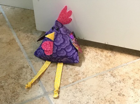 Fabric Chicken Doorstop - being used as a doorstop