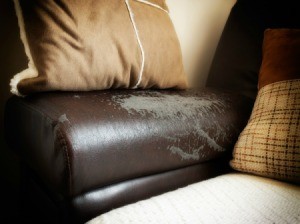 A worn brown leather sofa.