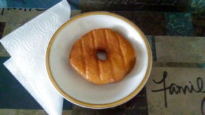 A grilled doughnut on a plate.