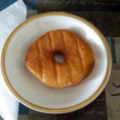 A grilled doughnut on a plate.