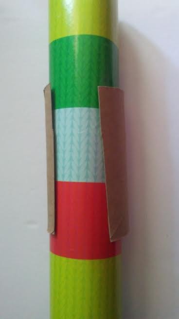 A toilet paper tube holding wrapping paper closed.