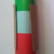 A toilet paper tube holding wrapping paper closed.