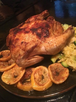 Moroccan Chickenon plate with lemon wedges
