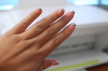 A hand with press-on nails applied.