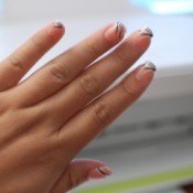 A hand with press-on nails applied.