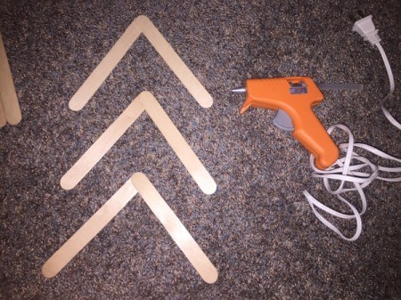 Popsicle Stick Wall Arrow - glue two sticks together to make an angle, create three of these
