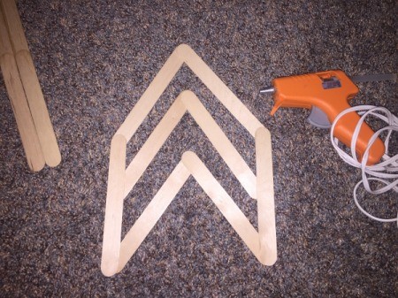 Popsicle Stick Wall Arrow - Glue one Popsicle stick on each side of the angled Popsicle sticks.
