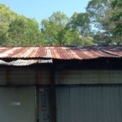 Inexpensive Roof Replacement for Low Income Homeowner - rusted tin roof on old mobile home