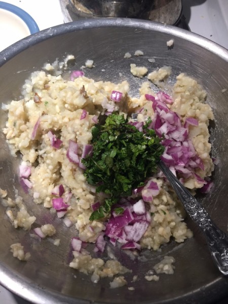 cauliflower, onion, potatoes and herbs in bowl