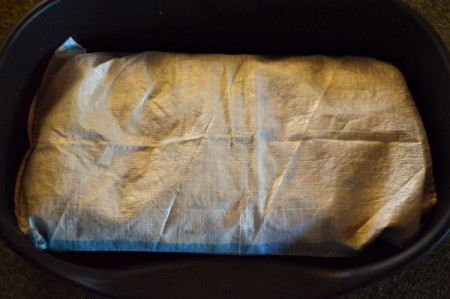 A polypropylene bag that has been turned into a dog mattress.