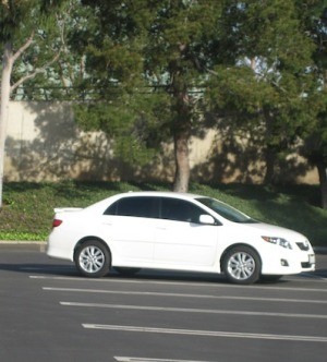 A white car parked in a parking lot.