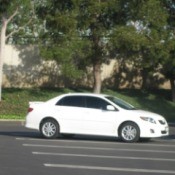 A white car parked in a parking lot.