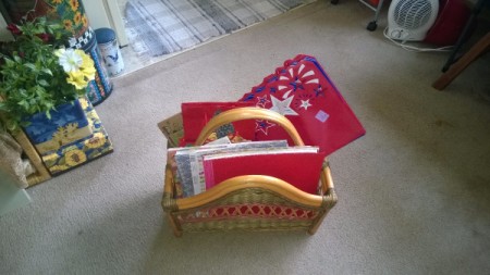 A magazine rack with greeting cards stored inside.