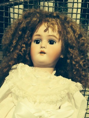 Finding the Value of an Antique German Doll - doll with curly dark hair
