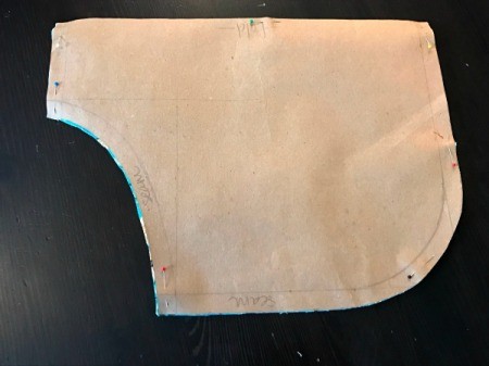 Clothespin Apron = paper pattern still pinned to flowered fabric