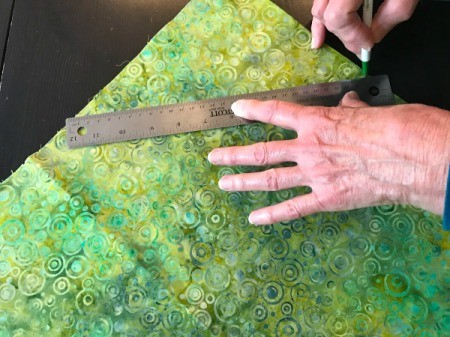 Clothespin Apron - drawing lines on green batik for bias binding