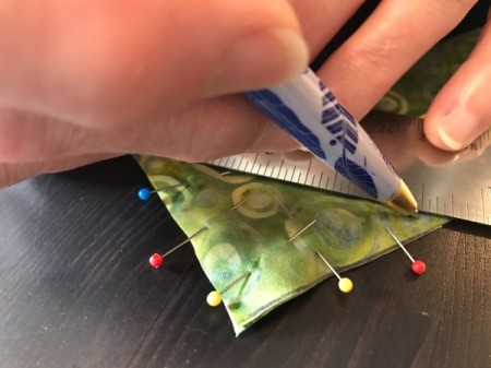 Clothespin Apron - bias strips pinned at right angles and then marking the stitch line