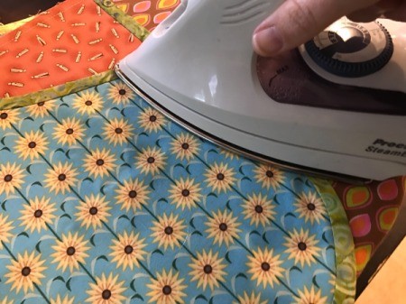 Clothespin Apron - press the apron and recently attached binding prior to attaching waistband