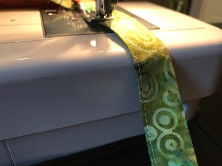 Clothespin Apron - begin topstitching on ties close to edge